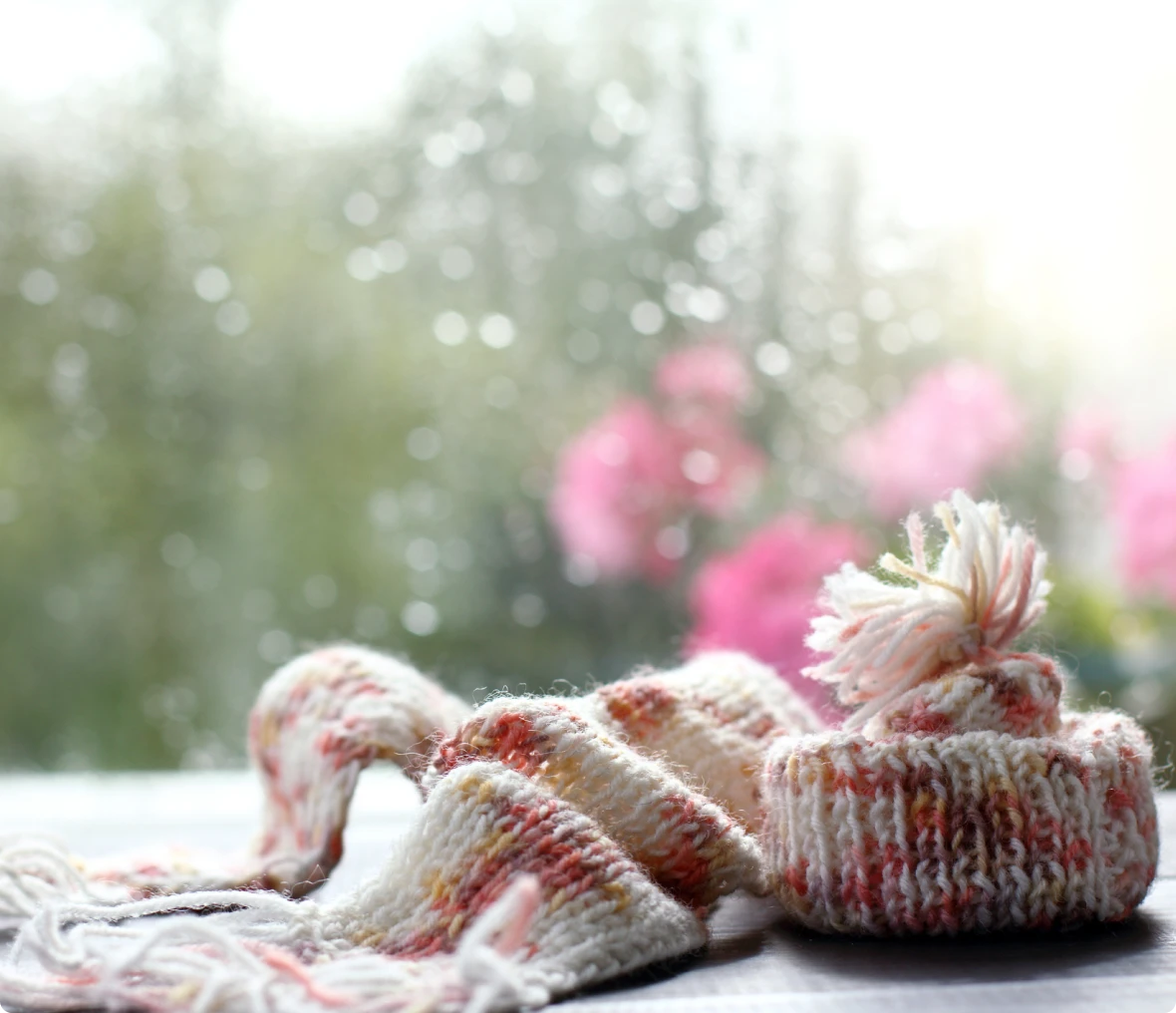 Cozy winter accessories with blurred flowers