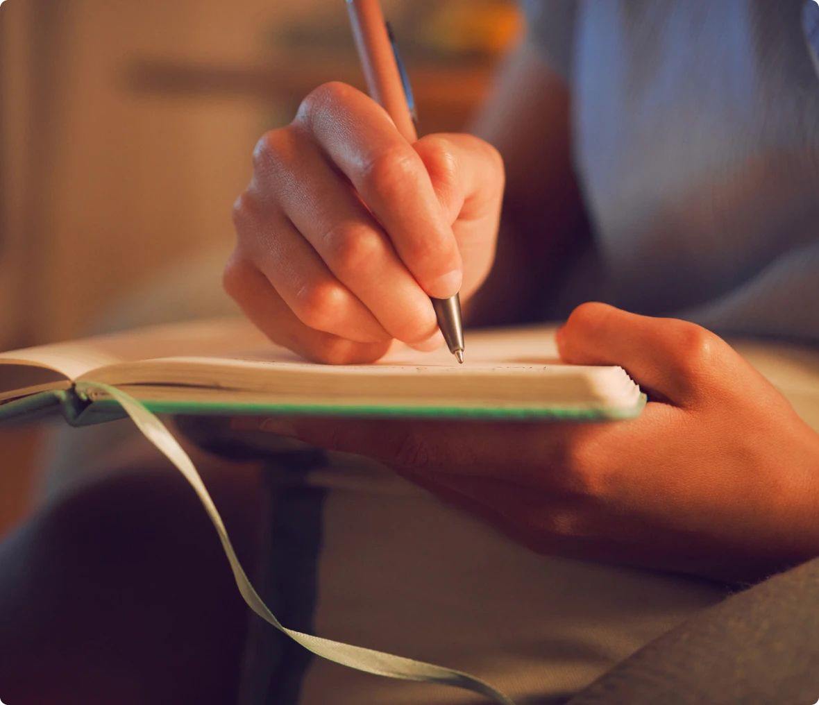 Writing in a journal at home