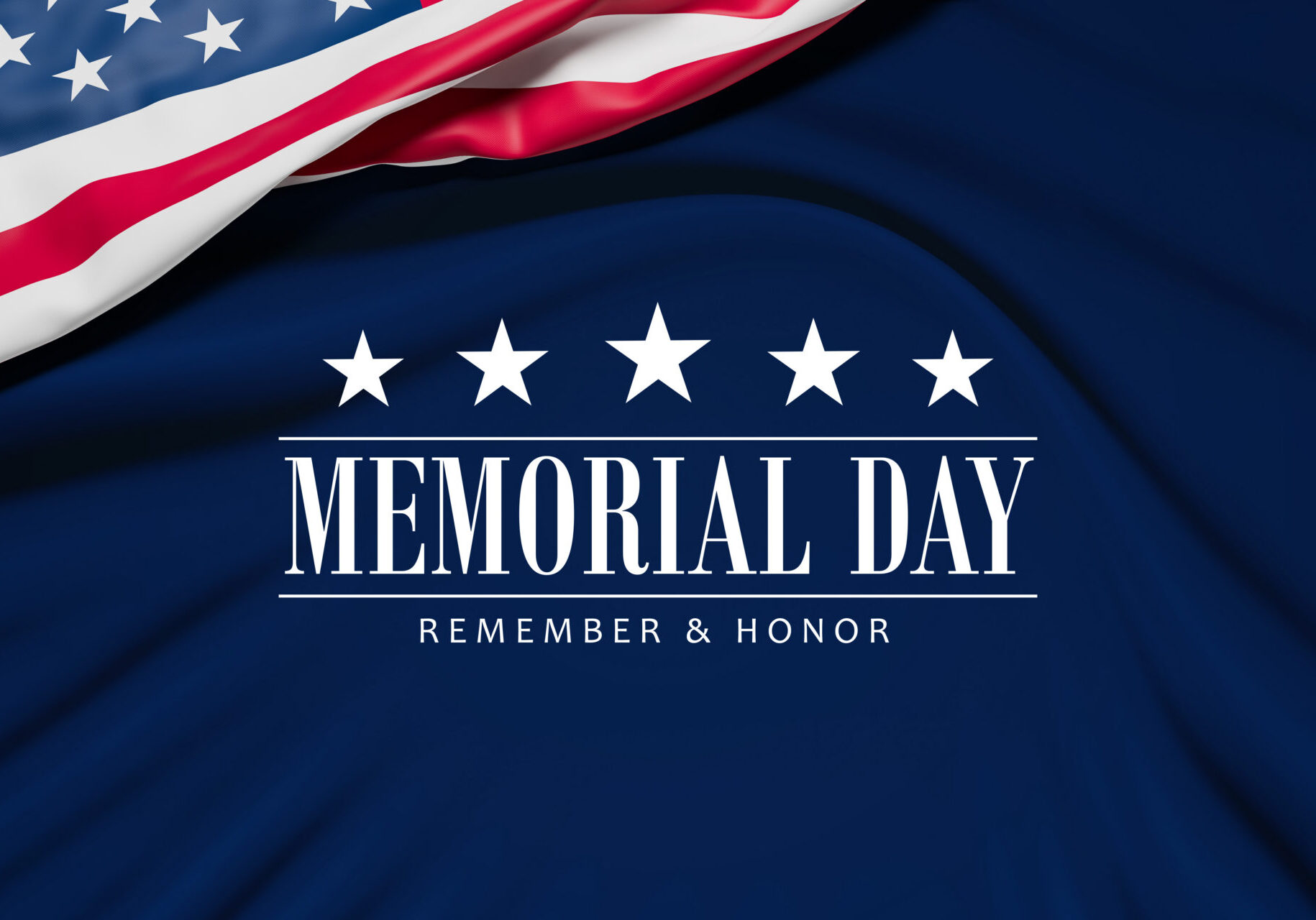 The wrinkled flag of the USA draped onto a blue velvet surface and the text "Memorial Day - Remember and Honor"