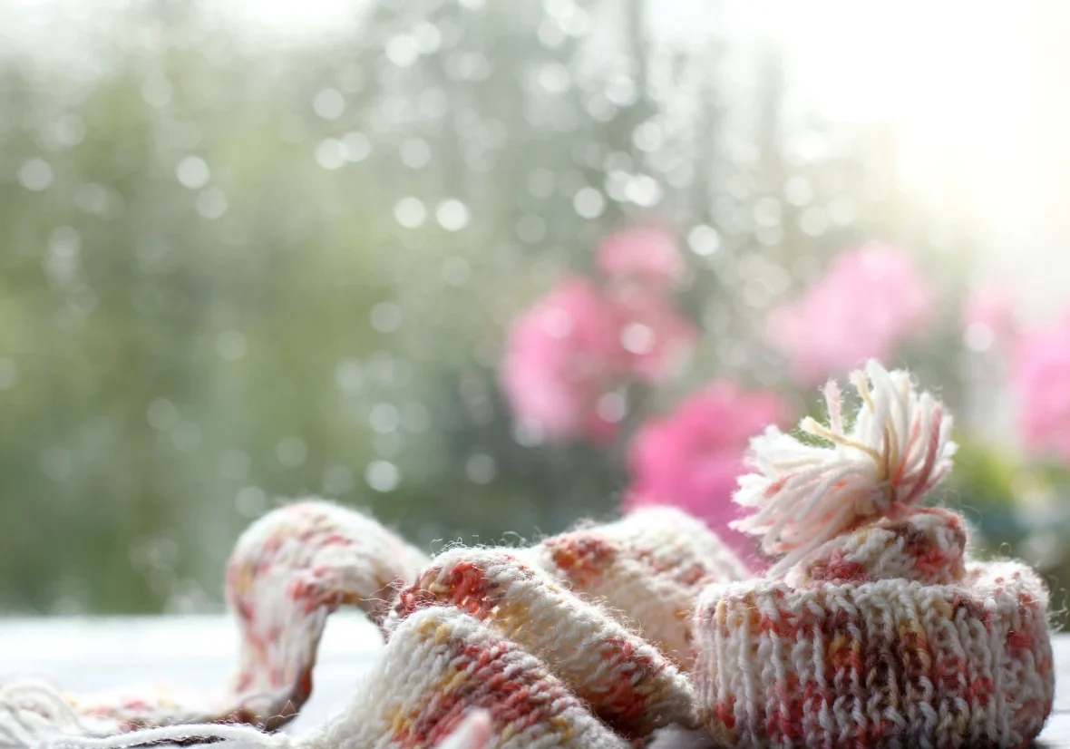 Cozy winter accessories with blurred flowers