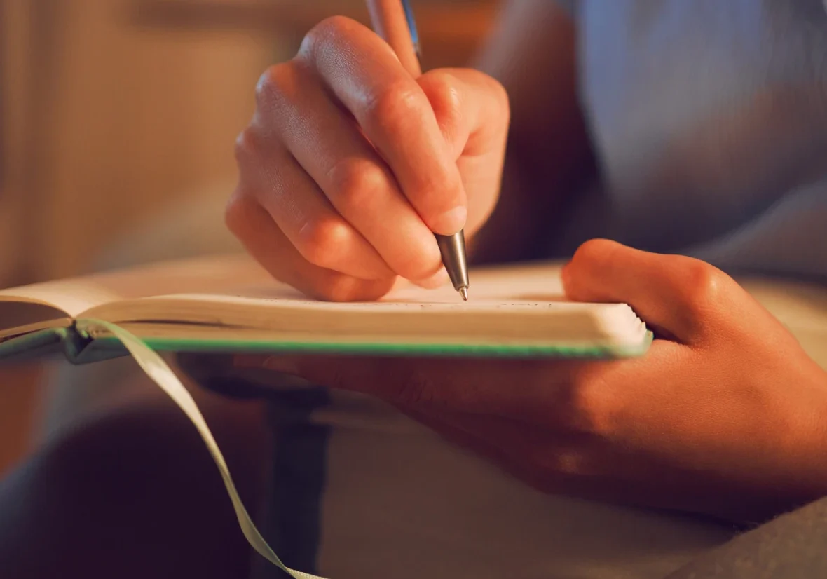 Writing in a journal at home